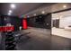Home gym featuring rubber flooring, mirrored wall, and storage at 4960 S Lipan Dr, Englewood, CO 80110