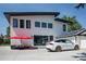 Modern two-story house with a red umbrella and Tesla in the driveway at 4960 S Lipan Dr, Englewood, CO 80110
