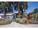 Charming house exterior with a landscaped yard and playground at 4960 S Lipan Dr, Englewood, CO 80110