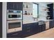 Modern kitchen with double ovens and sleek countertops at 4960 S Lipan Dr, Englewood, CO 80110