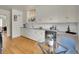 Bright kitchen with white cabinets, granite counters, and hardwood floors at 200 Colorado Blvd, Denver, CO 80206