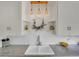 White farmhouse sink and updated lighting fixtures at 200 Colorado Blvd, Denver, CO 80206