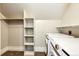 Convenient laundry room with washer, dryer, shelving and hanging rod at 212 S Sherman St, Denver, CO 80209