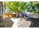 Landscaped backyard with patio, raised garden beds, and storage shed at 212 S Sherman St, Denver, CO 80209