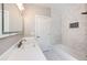 Updated bathroom with white vanity, marble tile, and a bathtub at 212 S Sherman St, Denver, CO 80209