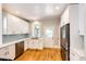 Modern white kitchen with stainless steel appliances and light blue backsplash at 212 S Sherman St, Denver, CO 80209