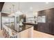 Modern kitchen with dark cabinetry, large island, and high-end appliances at 357 S Franklin St, Denver, CO 80209