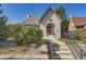 Front view of a charming house with landscaping and walkway at 665 S Gilpin St, Denver, CO 80209