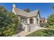 Charming bungalow with gray roof, white brick, and well-manicured lawn at 665 S Gilpin St, Denver, CO 80209