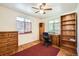 Bright bedroom featuring a desk, bookcase, and dresser at 7650 W 26Th Ave, Lakewood, CO 80214