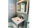 Modern bathroom vanity with gray tile and updated fixtures at 2403 Newland St, Edgewater, CO 80214