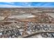 An aerial view of a residential neighborhood with a pond and homes at 10993 Ledges Rd, Parker, CO 80134