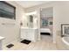 Bright bathroom with white vanity, soaking tub, and a view into the bedroom at 10993 Ledges Rd, Parker, CO 80134