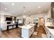 Open concept kitchen with a large island and modern finishes at 8860 S Quatar Ct, Aurora, CO 80016