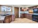 Galley style kitchen with wood cabinets and granite countertops at 217 S 25Th Ave, Brighton, CO 80601