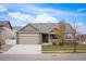 Ranch style home with a two-car garage and landscaped front yard at 1631 Woodcock St, Berthoud, CO 80513