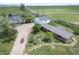 Aerial view of a home with attached garage and barn at 8045 N Moore Rd, Littleton, CO 80125