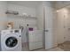 Laundry room with washer, dryer, and shelving at 472 S Norfolk Ct, Aurora, CO 80017