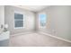 Well-lit bedroom featuring two windows and carpeted floors at 17415 Trefoil Ln, Parker, CO 80134