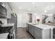 Kitchen island with white countertop and gray cabinets at 17415 Trefoil Ln, Parker, CO 80134