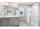 Bathroom with double vanity, gray cabinets, and shower at 17415 Trefoil Ln, Parker, CO 80134