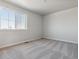 Bright bedroom featuring grey carpet and large window at 3282 N Highlands Creek Pkwy, Aurora, CO 80019