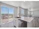Modern kitchen with island, stainless steel appliances, and access to deck at 3282 N Highlands Creek Pkwy, Aurora, CO 80019