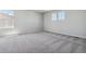 Spacious bedroom with grey carpet and two windows at 3282 N Highlands Creek Pkwy, Aurora, CO 80019