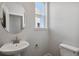 Small bathroom with a pedestal sink and toilet at 3282 N Highlands Creek Pkwy, Aurora, CO 80019