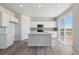 Modern kitchen with island, stainless steel appliances, and access to deck at 3282 N Highlands Creek Pkwy, Aurora, CO 80019