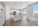 Modern kitchen with island, stainless steel appliances, and access to deck at 3282 N Highlands Creek Pkwy, Aurora, CO 80019