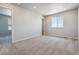 Spacious bedroom with neutral carpeting and large window at 3282 N Highlands Creek Pkwy, Aurora, CO 80019
