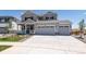 Two-story house with gray siding and two-car garage at 3282 N Highlands Creek Pkwy, Aurora, CO 80019
