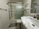 Bathroom with a shower/tub combo, vanity with marble countertop, and shelving at 7958 Downing St, Denver, CO 80229