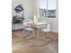 Light-filled dining area with contemporary table and four translucent chairs at 10848 Lyric St, Lone Tree, CO 80134