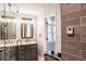 Spa-like bathroom with double sinks, walk-in shower, and large mirrors at 3790 S Roslyn Way, Denver, CO 80237