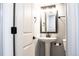 Updated bathroom with pedestal sink and modern fixtures at 3790 S Roslyn Way, Denver, CO 80237