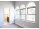 Spacious bedroom with three arched windows and ensuite bathroom at 3790 S Roslyn Way, Denver, CO 80237