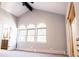 Spacious bedroom with vaulted ceiling, three arched windows, and ample closet space at 3790 S Roslyn Way, Denver, CO 80237