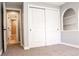 Bedroom with double sliding doors and ensuite bathroom at 3790 S Roslyn Way, Denver, CO 80237