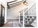 Bright entryway with an open staircase and stylish wood flooring at 3790 S Roslyn Way, Denver, CO 80237