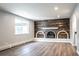 Gathering room featuring a rustic wood fireplace and hardwood floors at 3790 S Roslyn Way, Denver, CO 80237