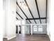 Open loft area overlooking the main living space with wood beams at 3790 S Roslyn Way, Denver, CO 80237