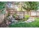 Landscaped backyard with serene pond and waterfall feature at 3790 S Roslyn Way, Denver, CO 80237