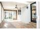 Sunroom with wood-paneled walls, stone flooring, and ceiling fan at 3790 S Roslyn Way, Denver, CO 80237