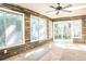 Bright sunroom features wood-paneled walls and stone flooring at 3790 S Roslyn Way, Denver, CO 80237