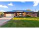 Brick ranch home with solar panels, attached garage, and a well-maintained lawn at 9941 Ammons Cir, Broomfield, CO 80021