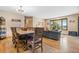 Bright dining area with a rustic wooden table and chairs, near the living room at 9941 Ammons Cir, Broomfield, CO 80021