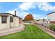 Landscaped backyard with lawn and garden at 9941 Ammons Cir, Broomfield, CO 80021