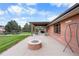 Brick patio with firepit, covered seating area, and hot tub at 9941 Ammons Cir, Broomfield, CO 80021